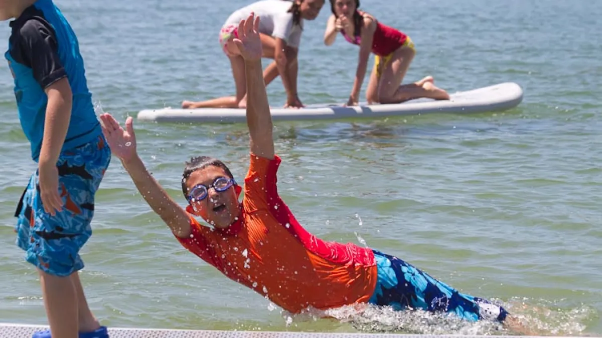 a couple of people that are standing in the water