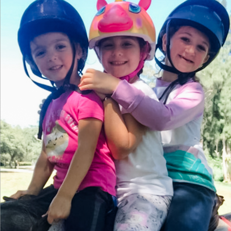 a little girl wearing a helmet