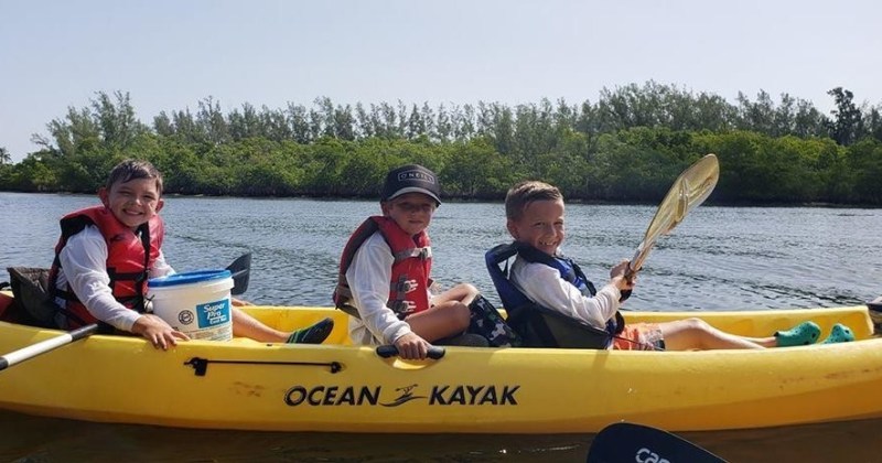 Summer Camp Image 1 Kids paddling in kayak on water in Jupiter, Florida