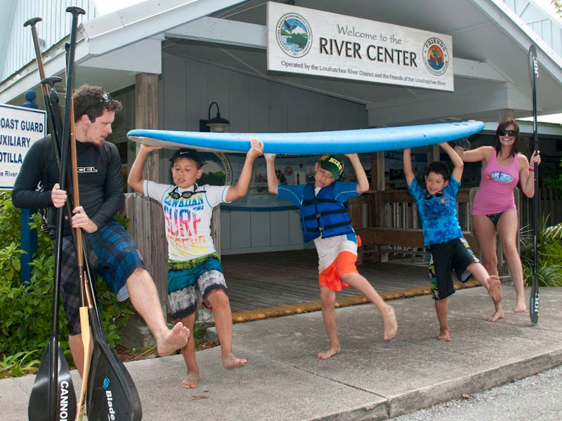 joc-camp-rivercenter-kids-dancing-with-paddleboard Group of children carrying surfboard in Jupiter Florida