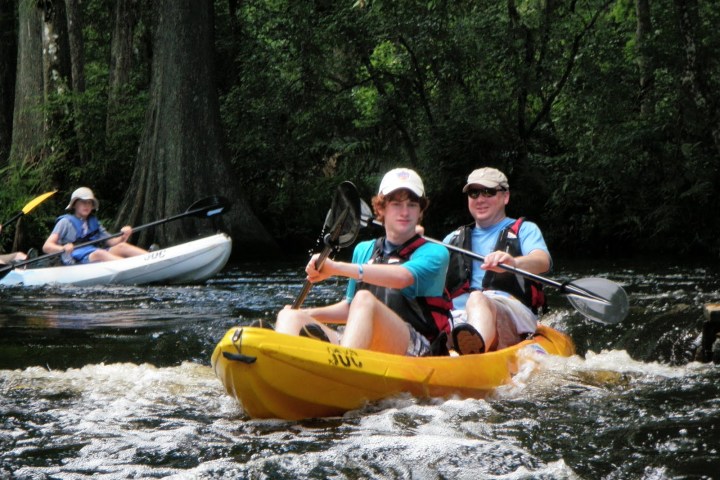 Kayakers paddling through Riverbend Park