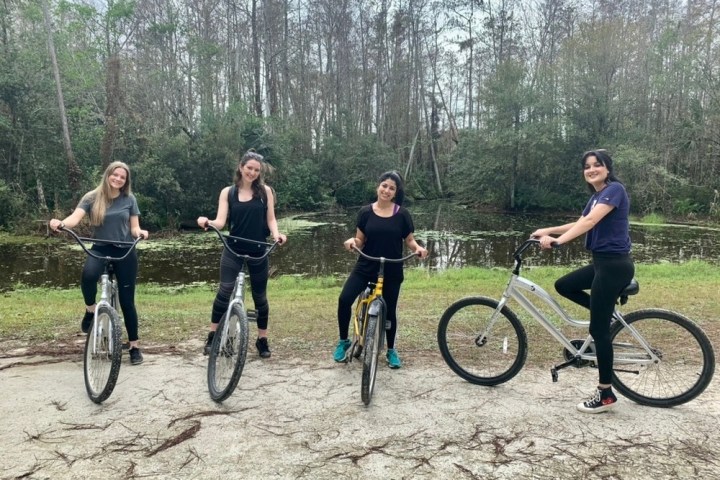 a group of people riding on the back of a bicycle