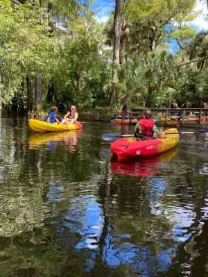 a group of people in a small boat in a body of water