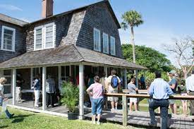 a group of people in front of a house