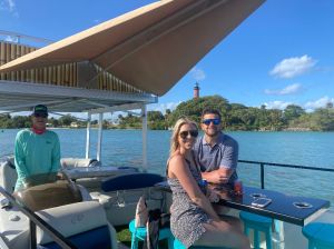 a man and a woman standing in front of a boat