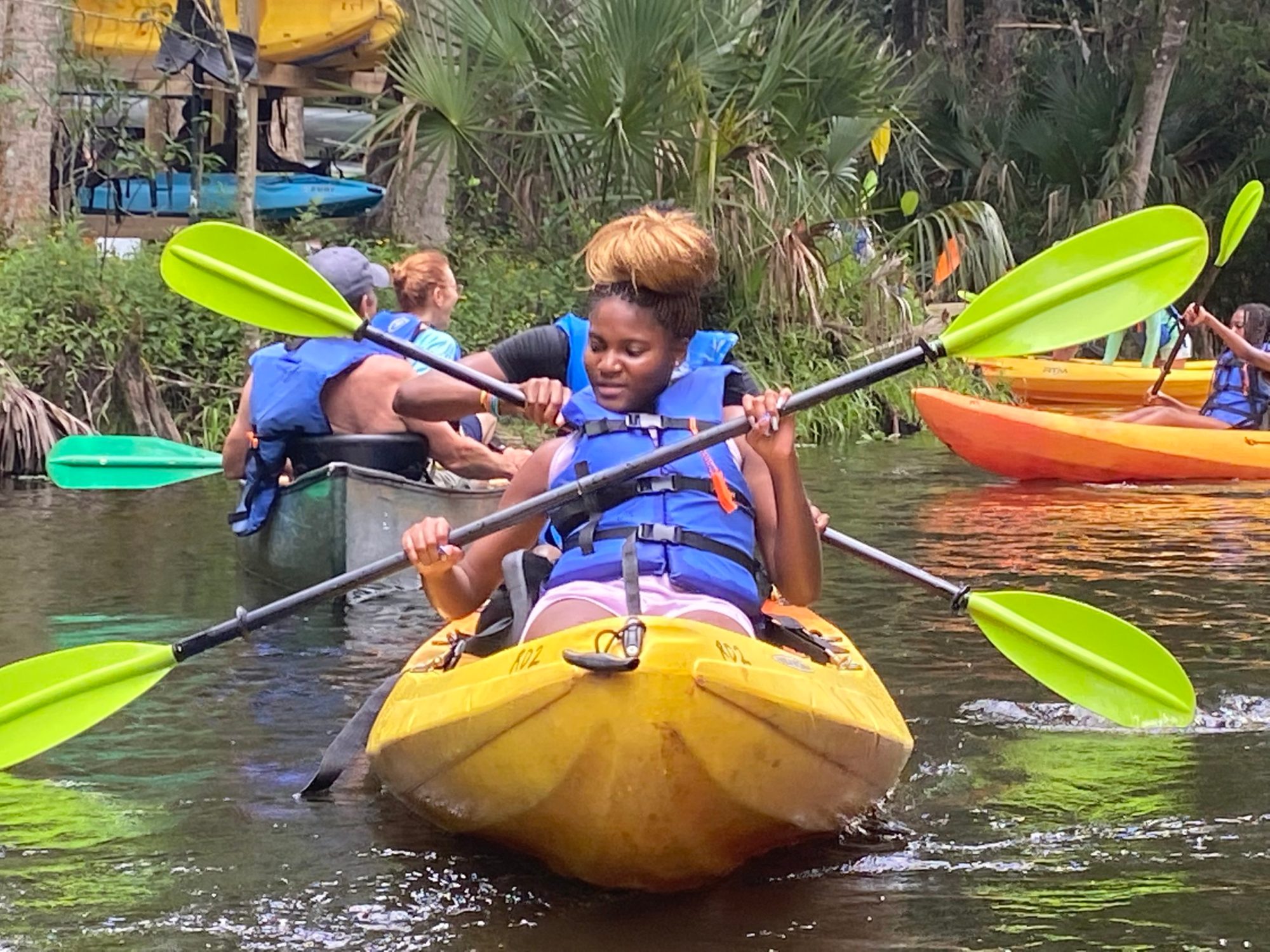 a young boy riding on a raft in a pool of water