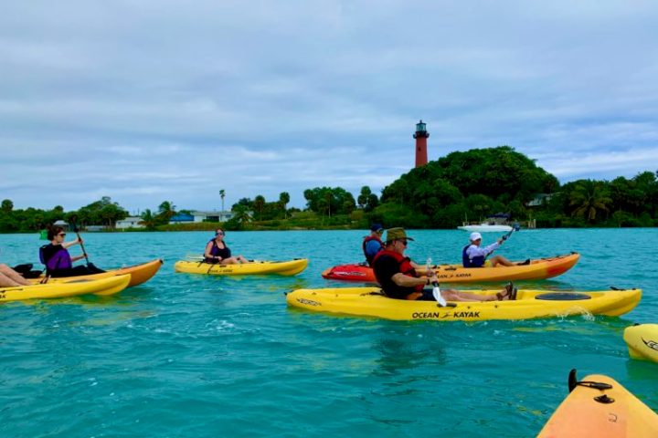 a group of people riding on the back of a boat in the water