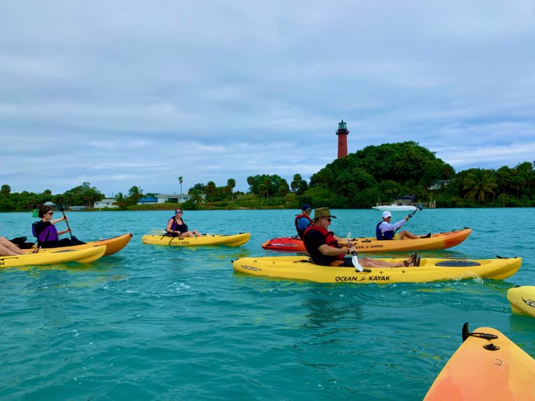 Lighthouse Group a group of people riding on the back of a boat in the water