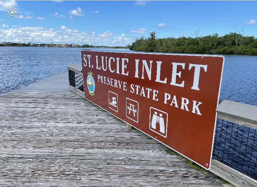 a sign above a body of water