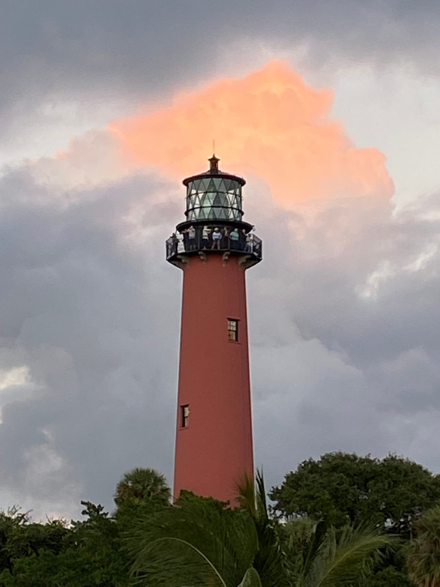 a large tall tower with a clock on the side of Nauset Light