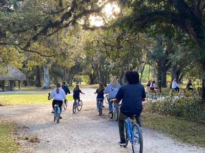 a group of people walking down a dirt road