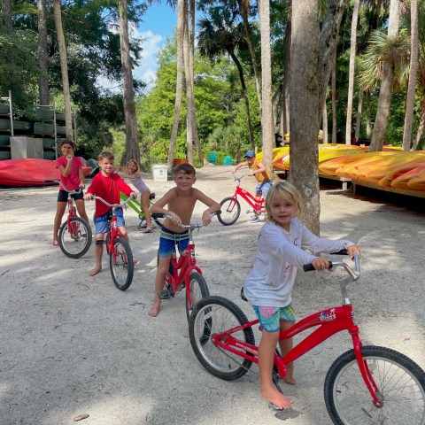Group of kids on bikes during summer camp at Riverbend Park in Jupiter, Florida