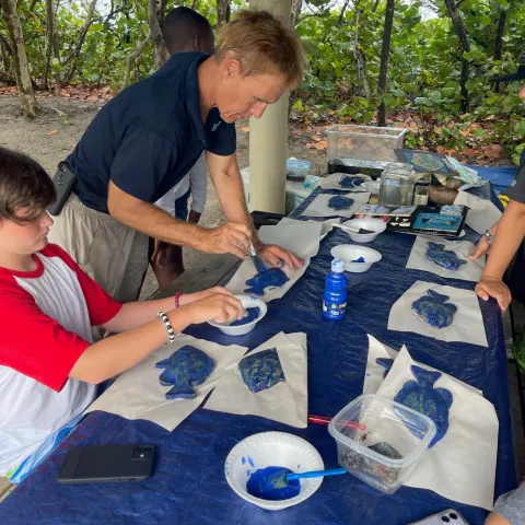 Children creating eco art with natural materials during summer camp at Jupiter Outdoor Center