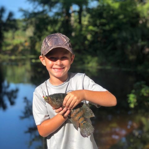 a man holding a fish