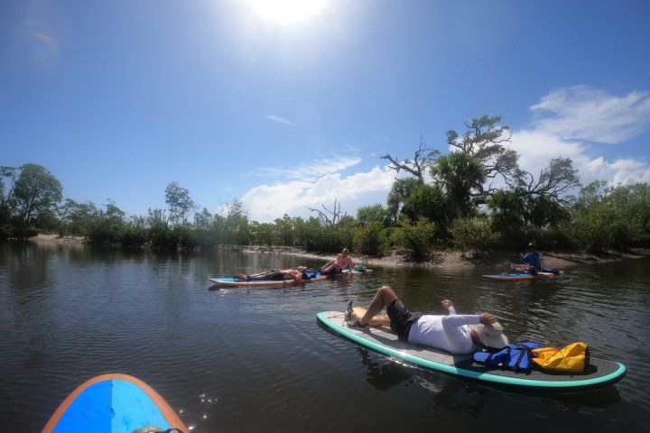 a group of people in a small boat in a body of water