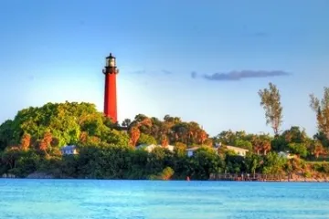 a large body of water with a lighthouse in the background