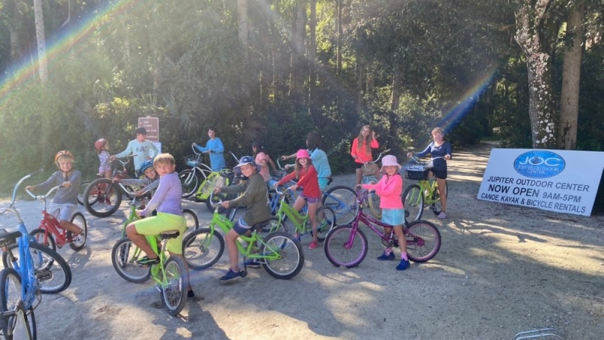 a group of people riding on the back of a bicycle