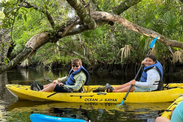 a group of people riding on the back of a boat