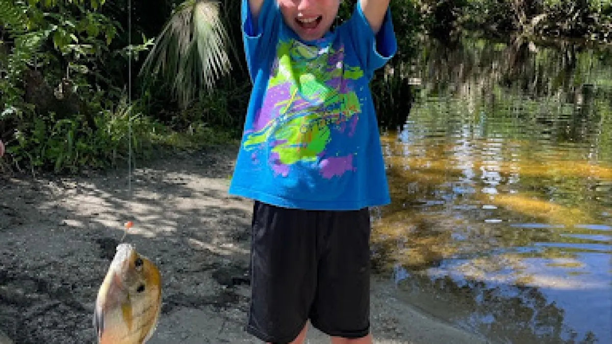 a little boy that is standing in the water