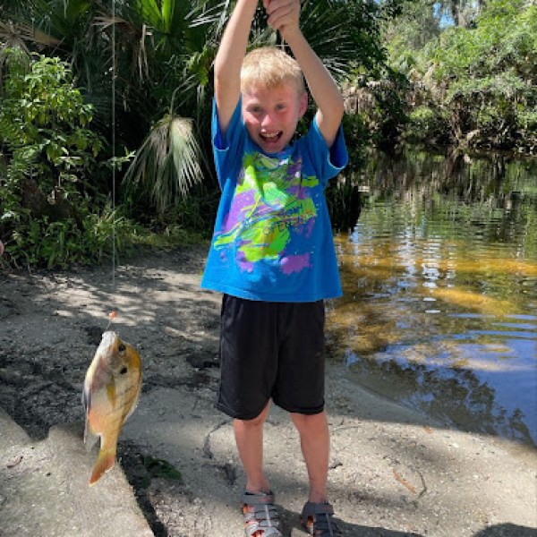 a little boy that is standing in the water