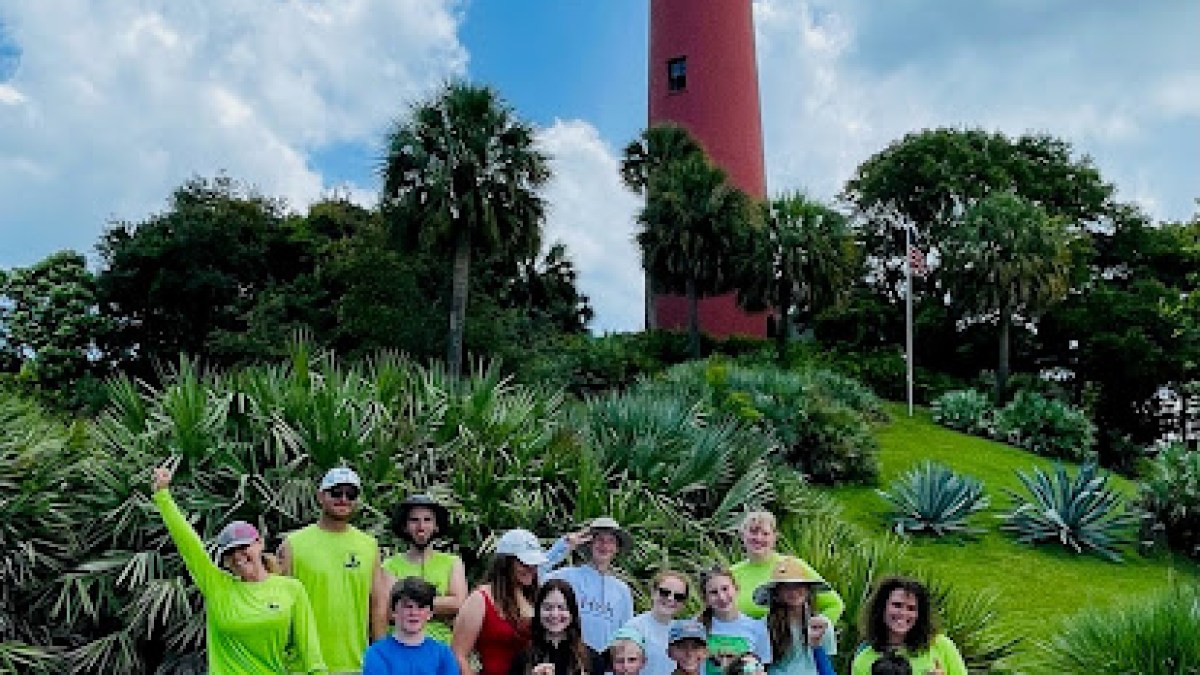 a group of people that are standing in the grass