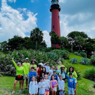 a group of people that are standing in the grass