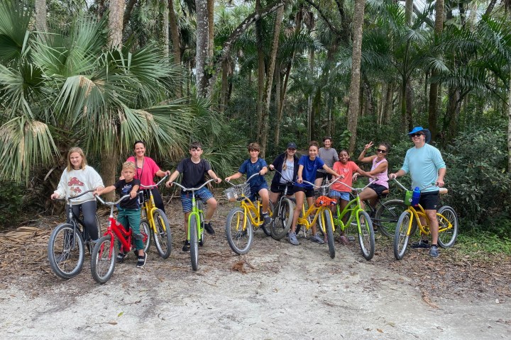 a group of people riding on the back of a bicycle