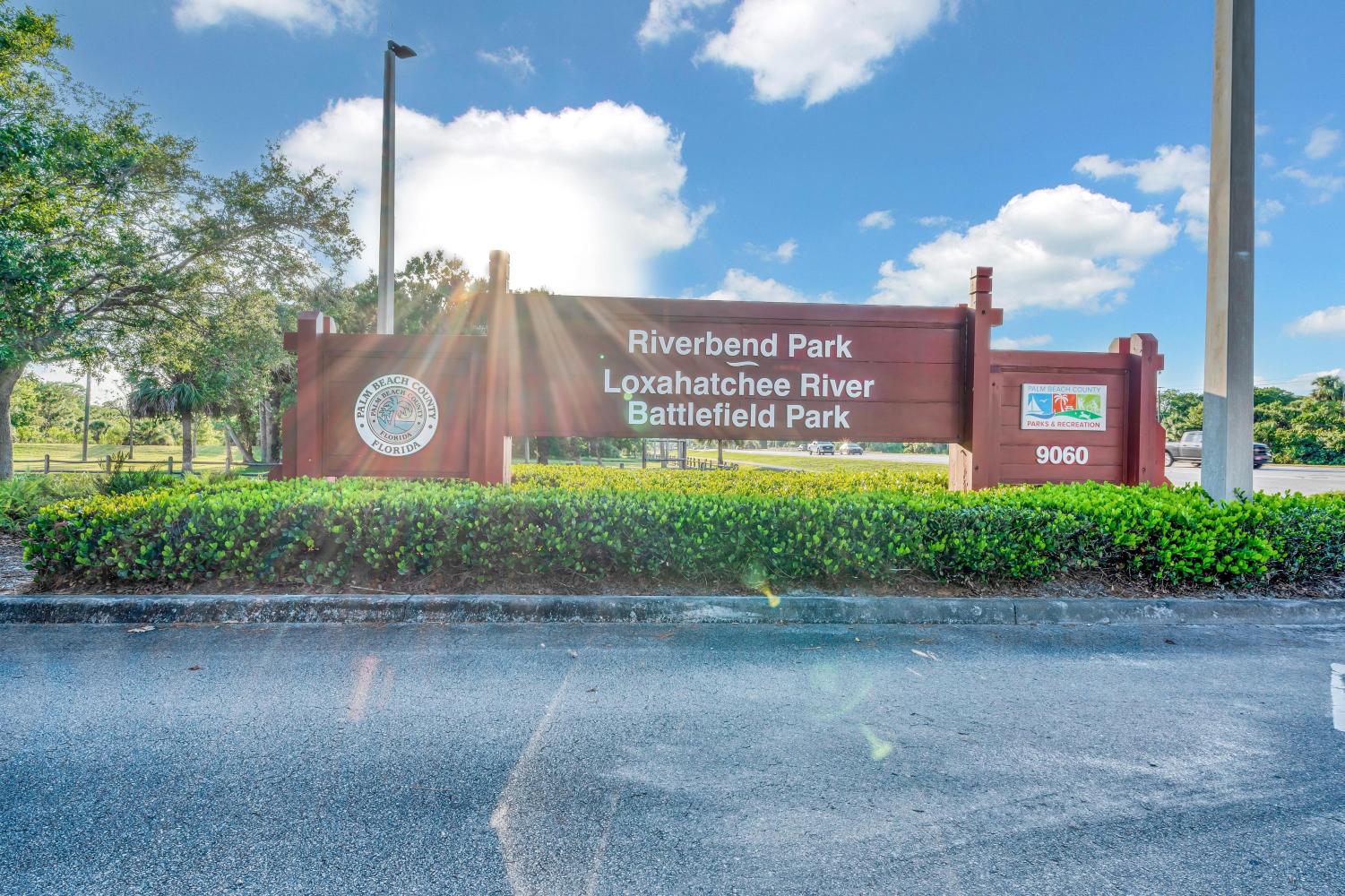 Entrance sign for Riverbend Park in Florida on a sunny day.